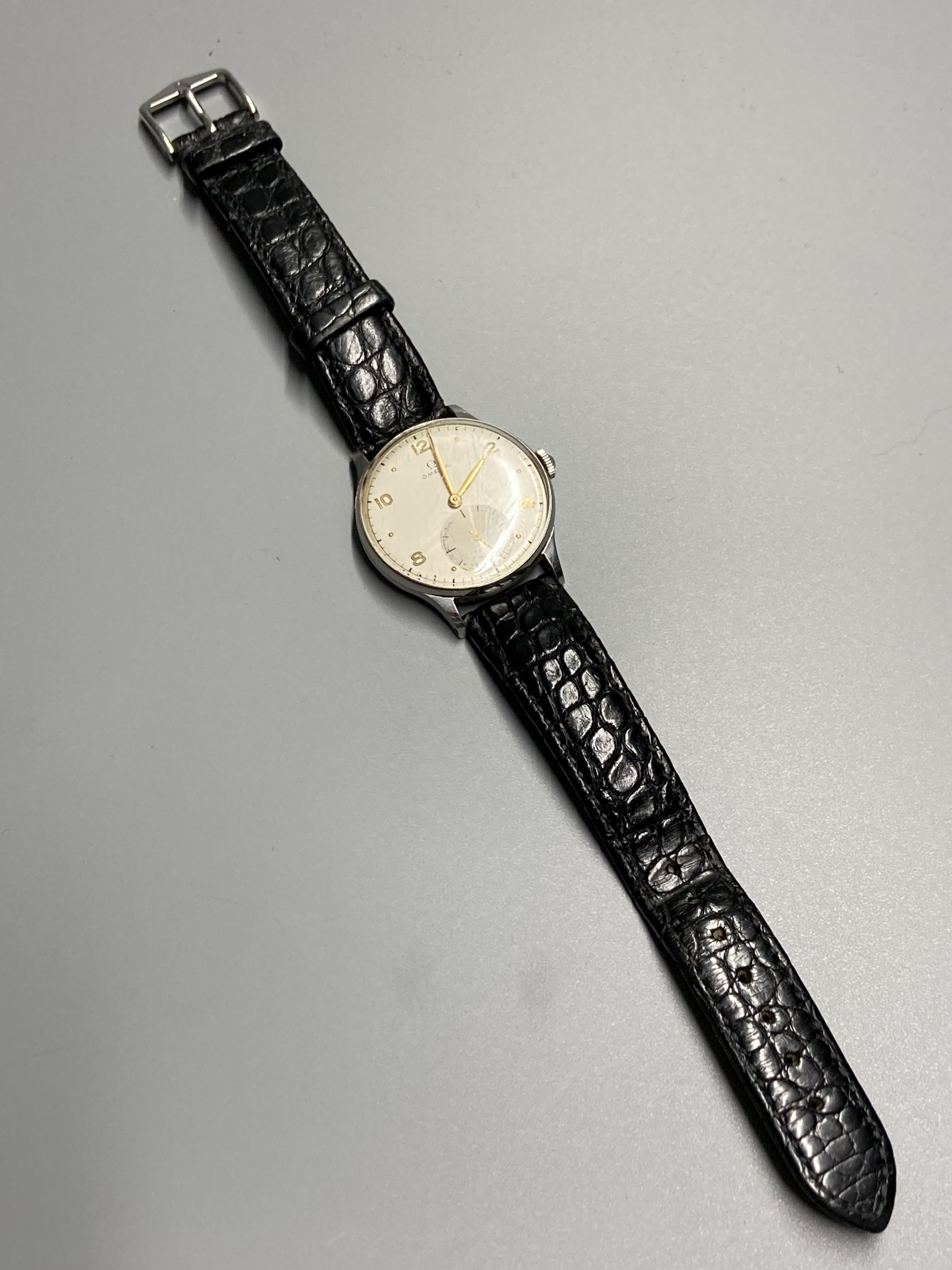 A gentlemans 1940s? stainless steel Omega manual wind wrist watch, with Arabic and dot numerals